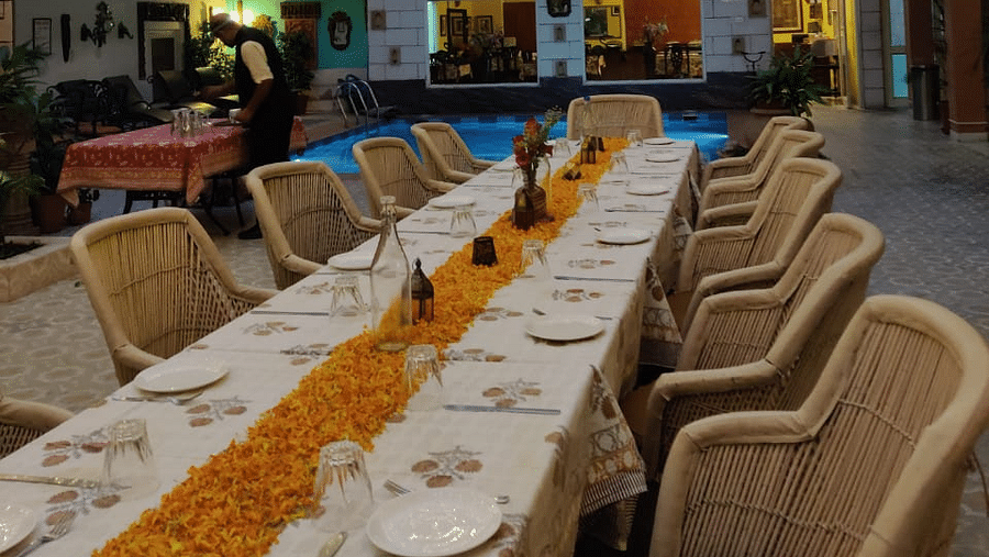 Seating arrangement with fairy lights on the top at Alfresco Dinner at the courtyard at Suryaa Villa Jaipur