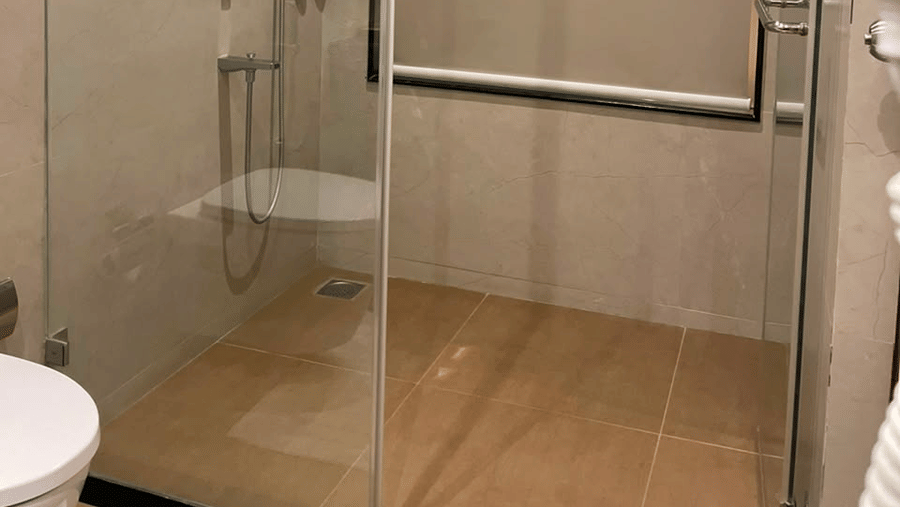 MM Legacy, Kanchipuram | A bathroom with a showerhead and other toileteries.
