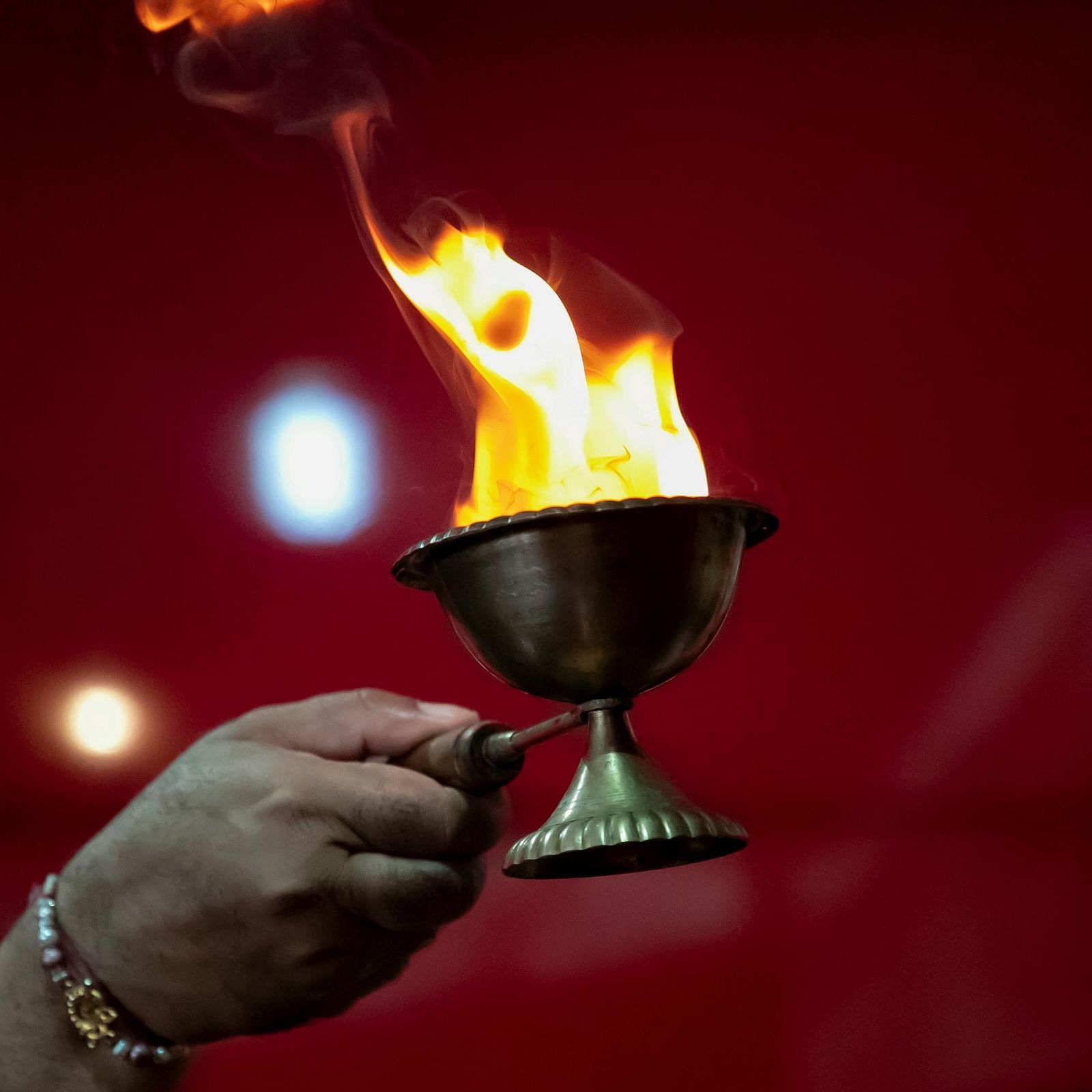An image of a person offering an aarti