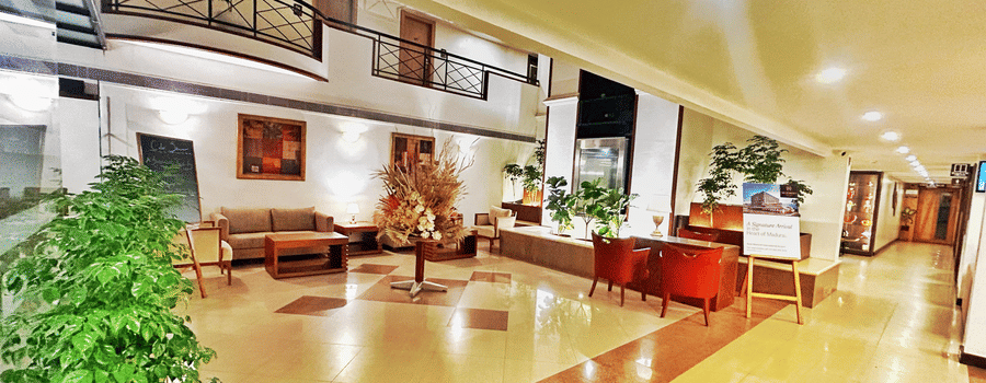 Spacious hotel lobby with elegant seating, warm lighting, and contemporary interiors.