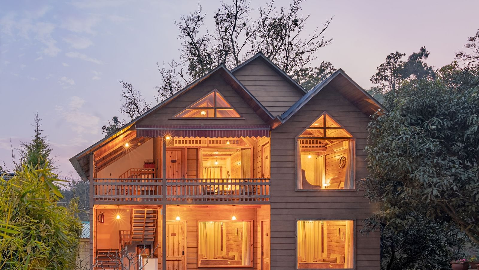 Facade view of Pinewood Cottage at dusk at the Sylvan Retreat, Dehradun.