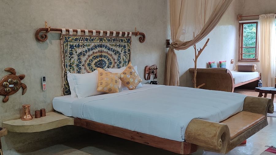 Close up view of the bed in snapper room with beautiful seating space attached to the bed, and contemporary beddings make the room pleasing and opulent.
