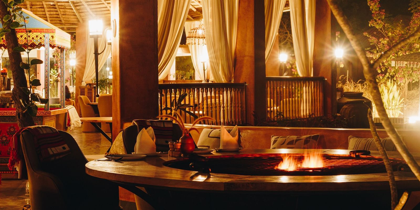 Night view of village lounge dining area at Surpura Bagh.