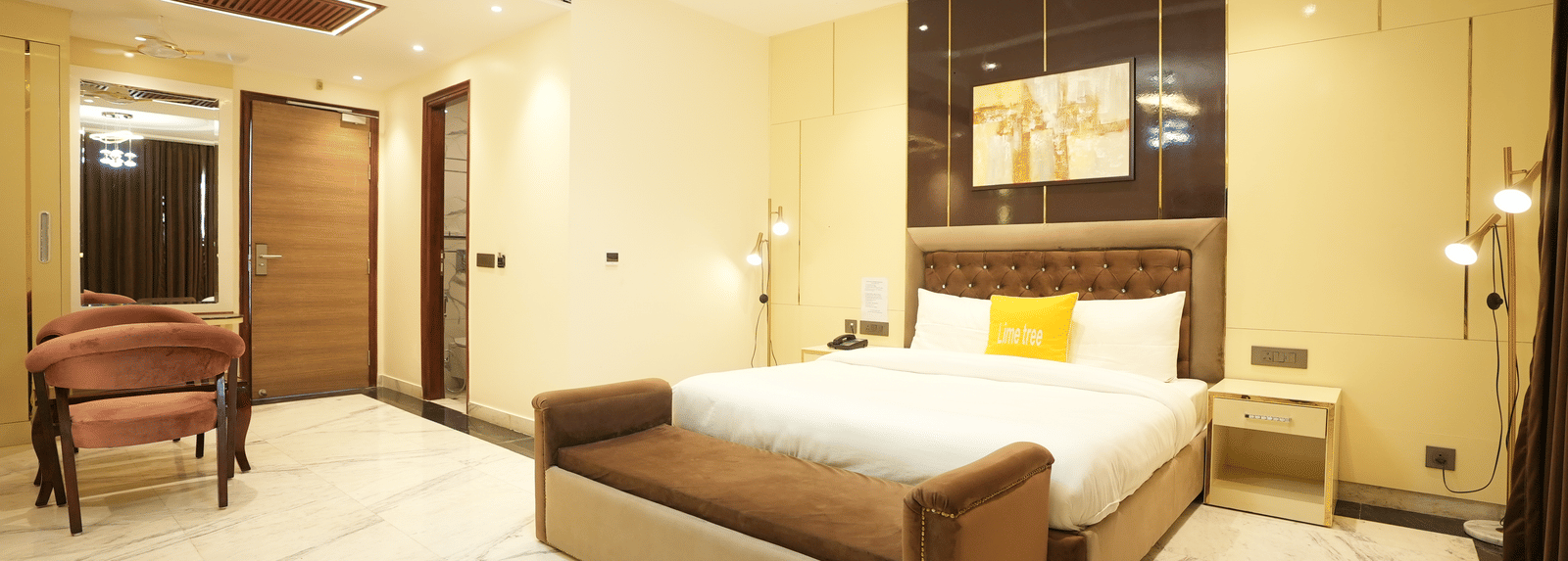 Spacious room with king size bed and seating area at Lime Tree Hotel Near India Expo Mart, Greater Noida.