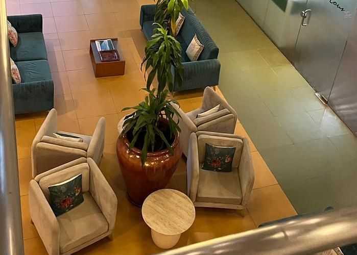 Spacious hotel lobby featuring comfortable seating and a multi-tiered chandelier - Astra Hotels and Suites Spice Garden