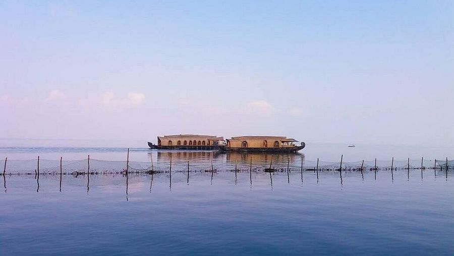 Two houseboats idling on blue backwaters - Rhythm Kumarakom