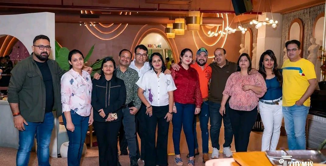 Group of friends posing together inside the restaurant at Themis Barbecue House, Ambala