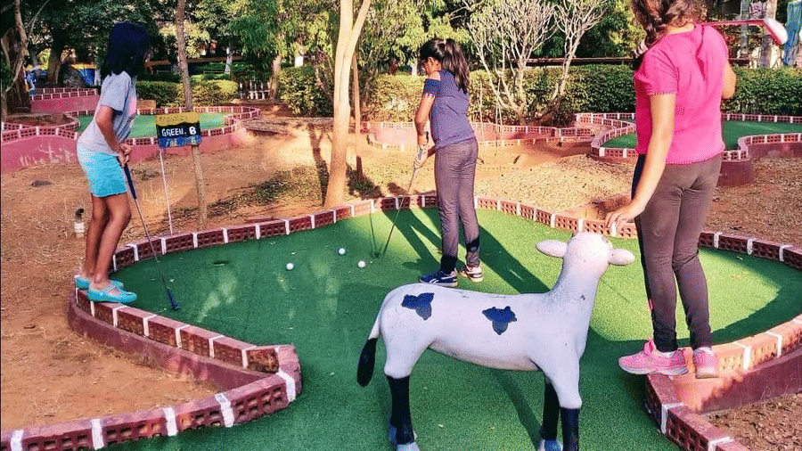 Children enjoying outdoor play area with fun animal rides at Fantasy Golf Resort.