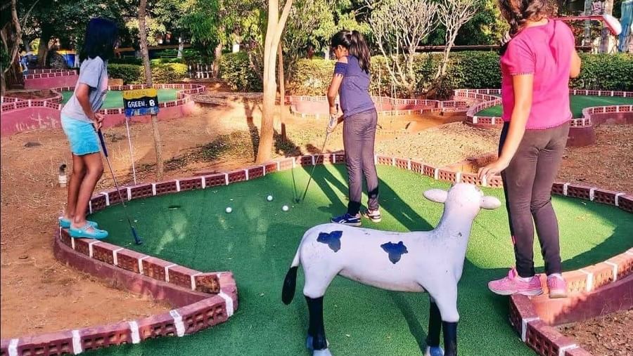 Children enjoying outdoor play area with fun animal rides at Fantasy Golf Resort.