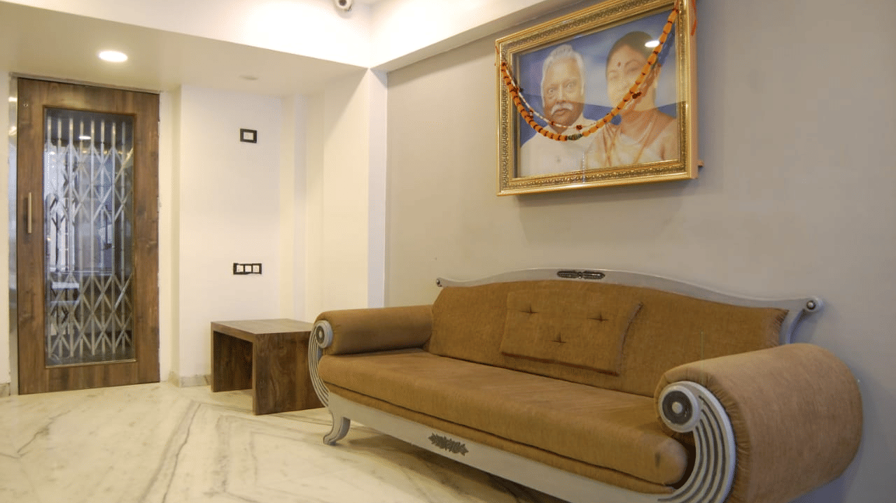 The reception sofa at adamo sanmukh with the picture of the ancestors of the founder.