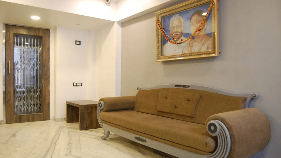 The reception sofa at adamo sanmukh with the picture of the ancestors of the founder.
