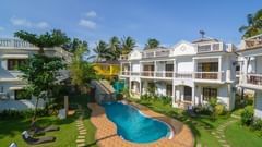 a bird's eye view of the hotel premises shows the pool surrounded by the hotel and palm trees - Richmonde Ananta Elite, Goa