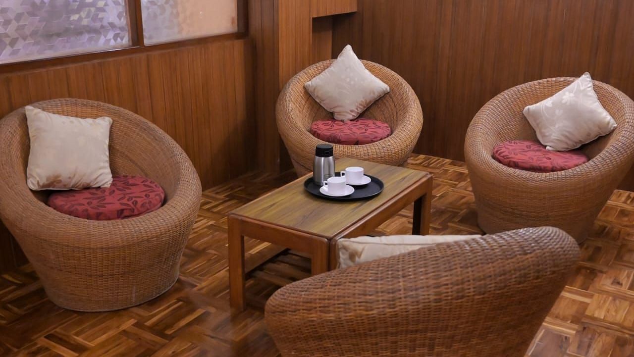 An image of a seating arrangement with bamboo sofa set at the family room in Ecotel Chiminda, Pelling