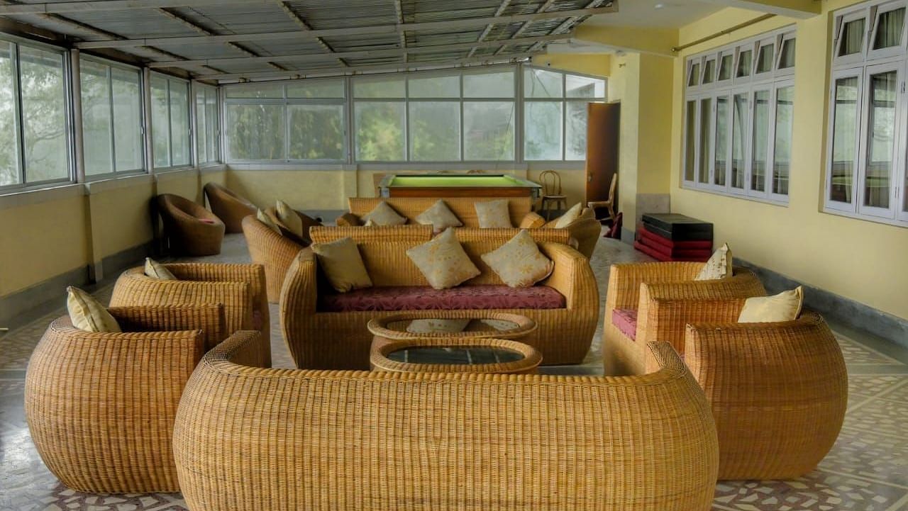 An image of the lobby area with sofa set overlooking the valleys - Sumitel Chiminda, Pelling