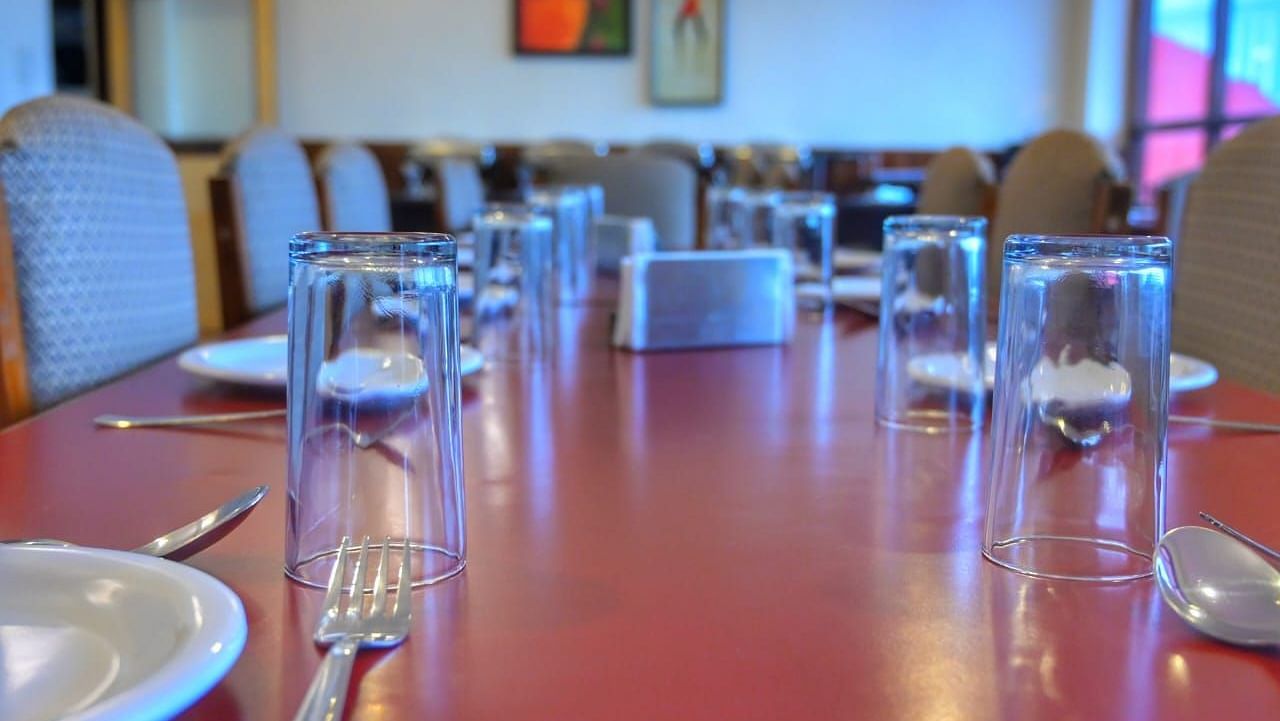 An image of a restaurant showcasing the seating arrangement and crockery and cutlery is laid on the table - Sumitel Chiminda, Pelling 