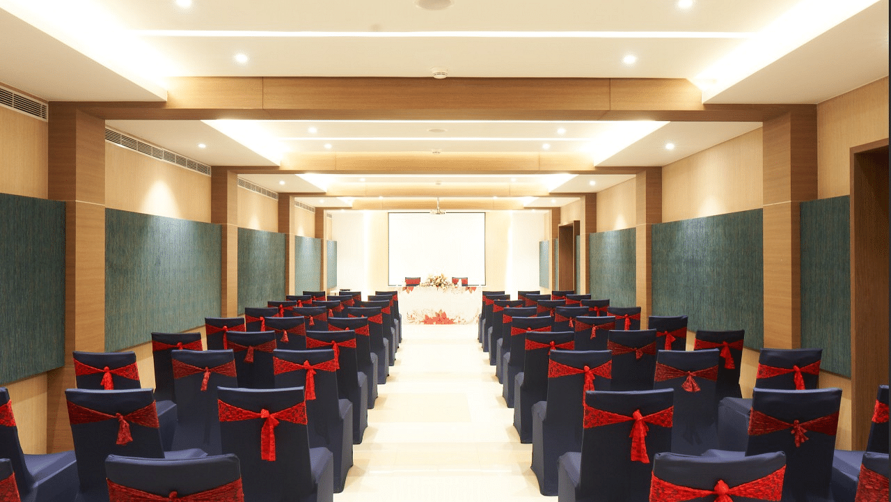 rear view of the hall with well arranged chairs at Grand Kakinada by GRT Hotels