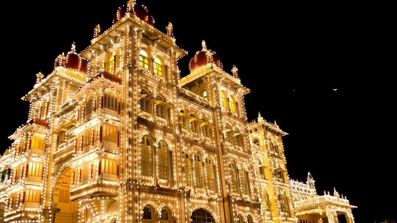 Illuminated palace glowing against the night sky with intricate architecture.