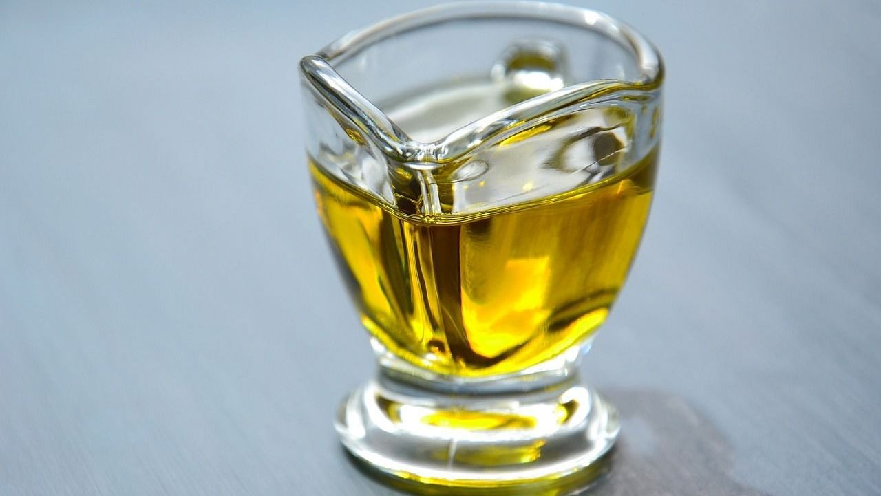  An image of a glass cup filled with golden olive oil
