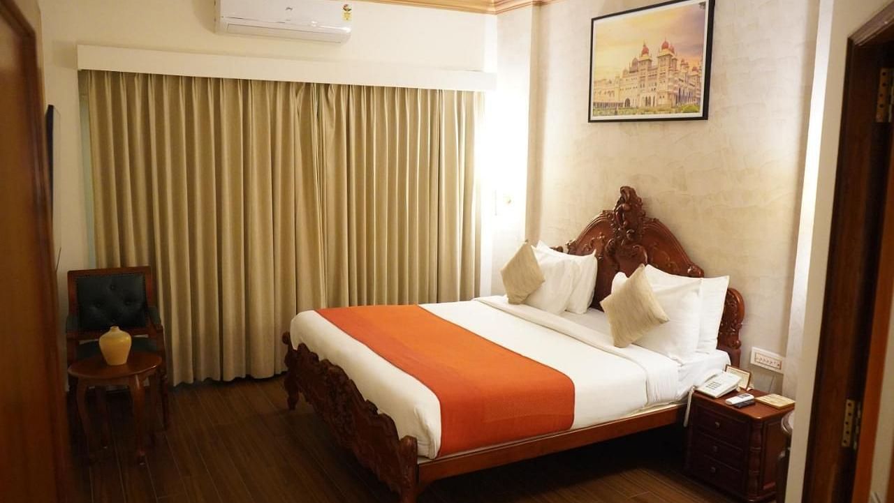 Royal Heritage Suite at Nalapad Hotel Bangalore International with a bed and side table. 