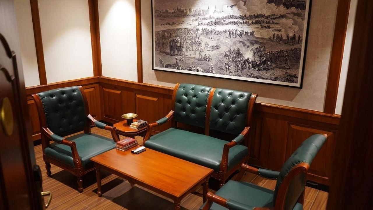 A seating area with two armchairs and a small table at Luxury King Room in Nalapad Hotel Bangalore International