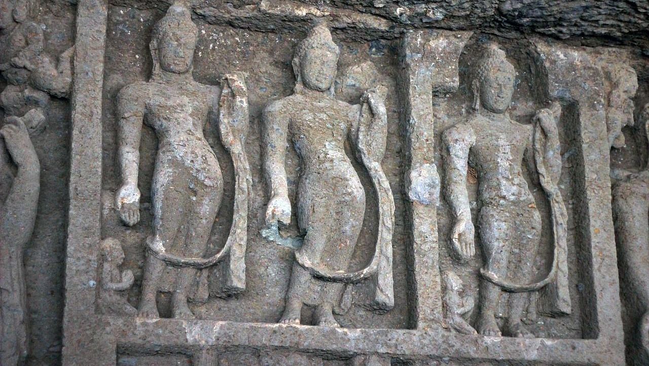 A close up shot of the intricately carved sculptures of women on the walls of the cave.