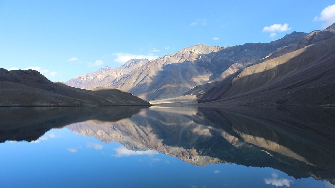 an overview of a lake with the reflection of the sky on the lake