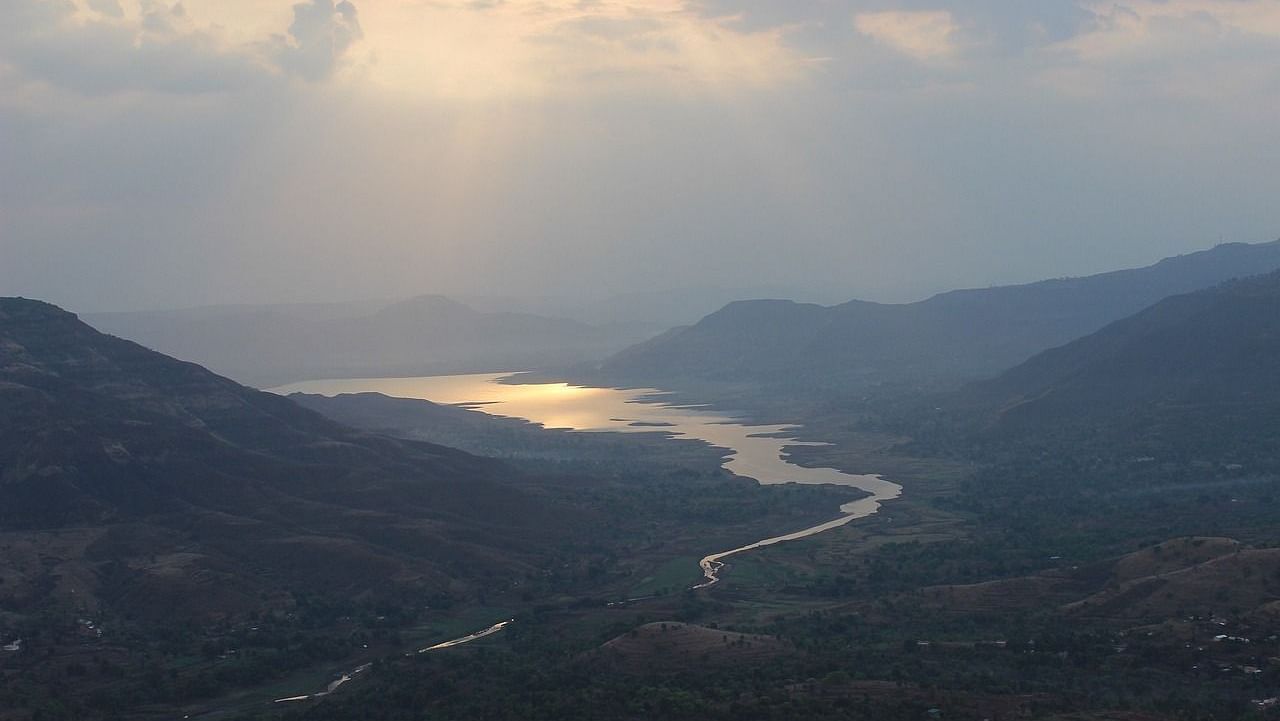 an image of a river moving between two mountains