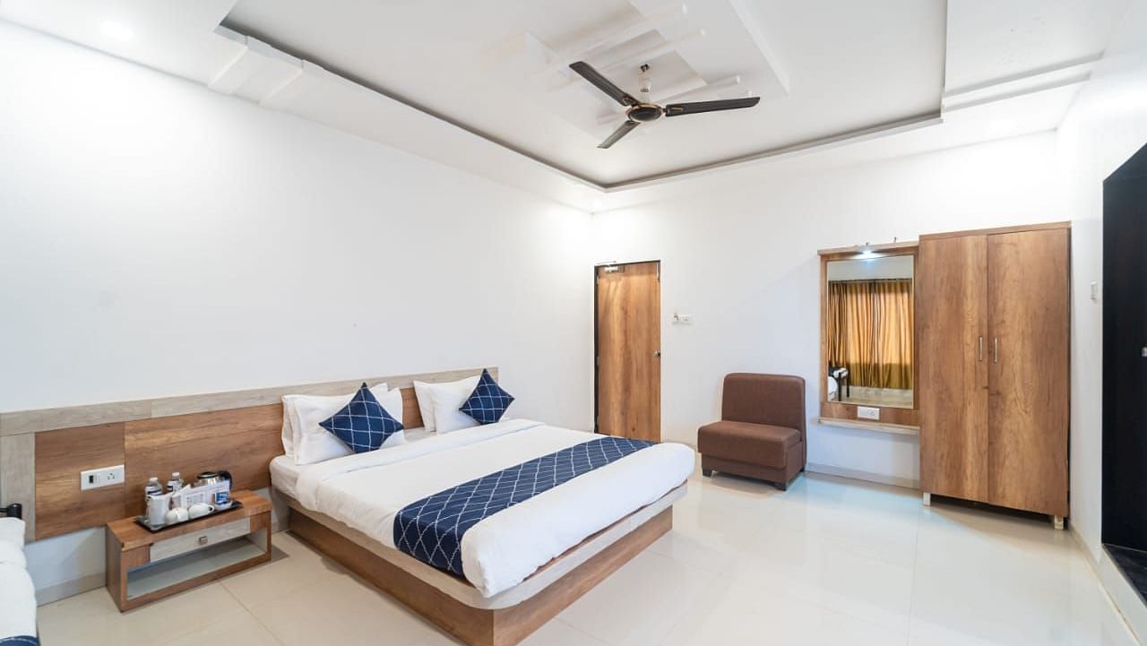 Penthouse Suite with Balcony with a king size bed, a nightstand, a chair, and a wardrobe.