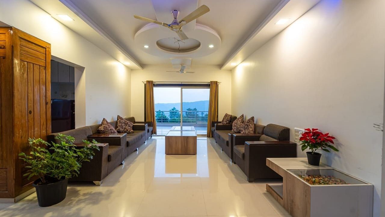 A hotel lobby with seating areas and a view to the outside.
