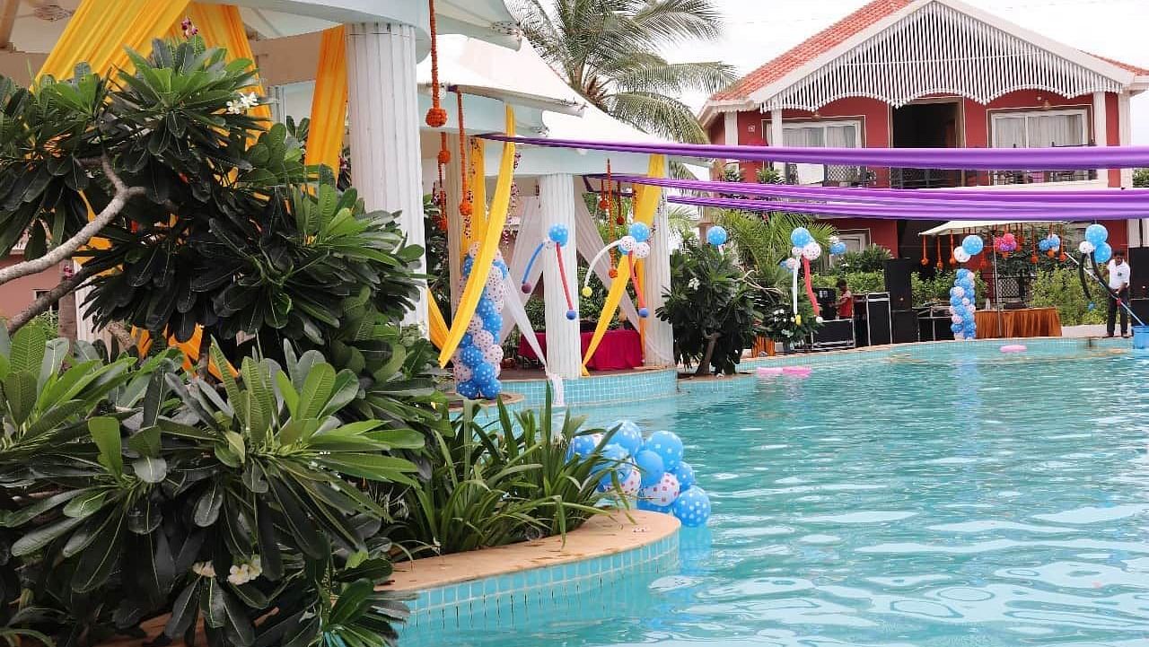 Villas by the pool at Swosti Resorts on a sunny day
