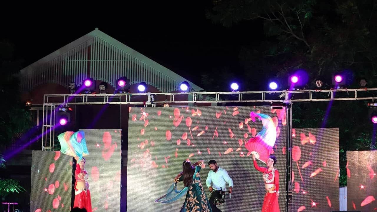 A dance performance on stage in the lawn at Swosti Resorts at night
