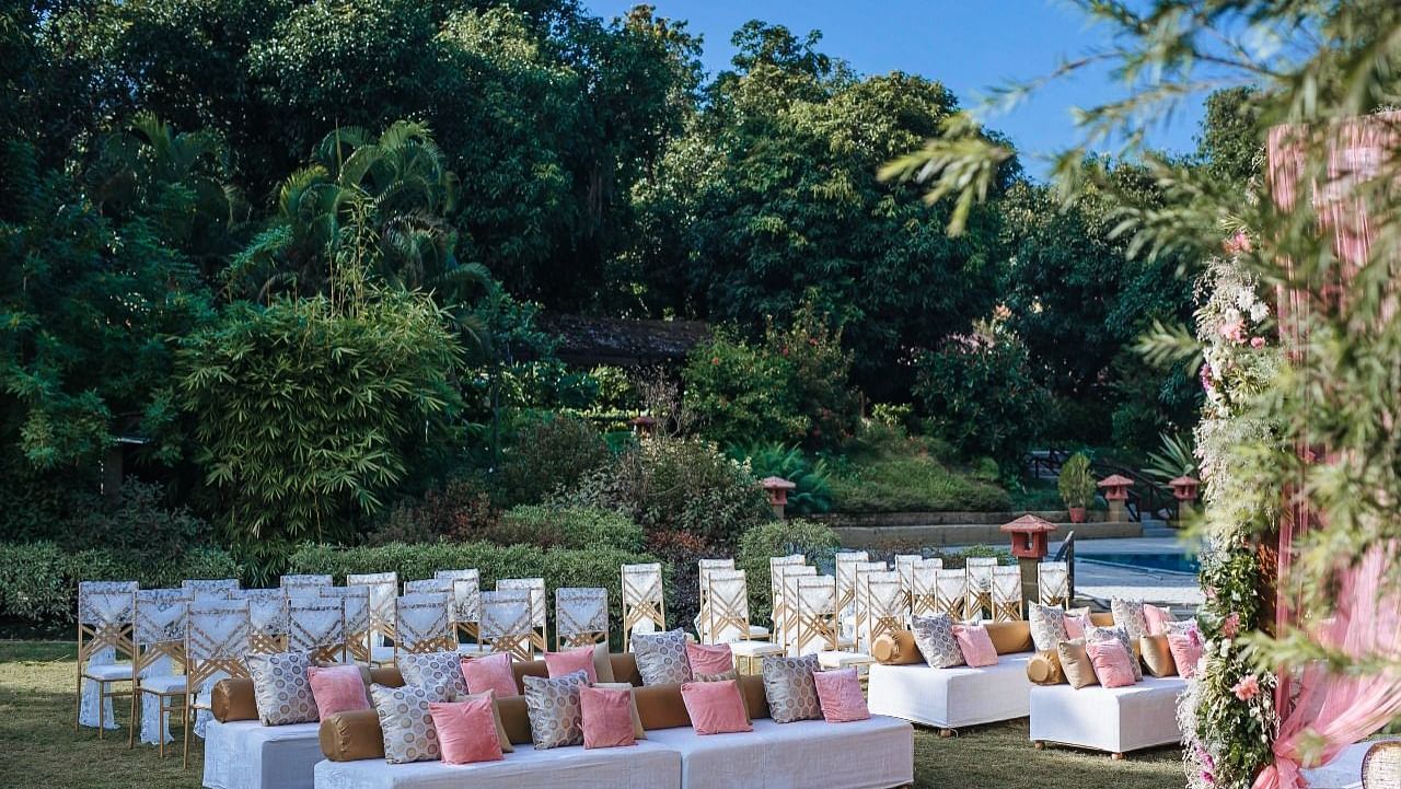  An image of a outdoor banquet hall with chairs and a stage decorated for destination wedding halls - Riverview Retreat, Corbett
