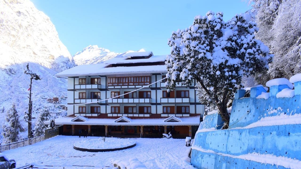 A facade image of Yashshree, Lachung where the hotel building and its surrounding is seen to be covered in snow