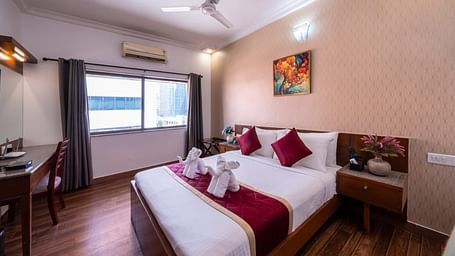 A cosy living room with comfortable sofas and wooden furniture offers a relaxing space at Lords Midtown Suites.