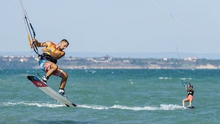 A close up shot of two tourists parasailing.