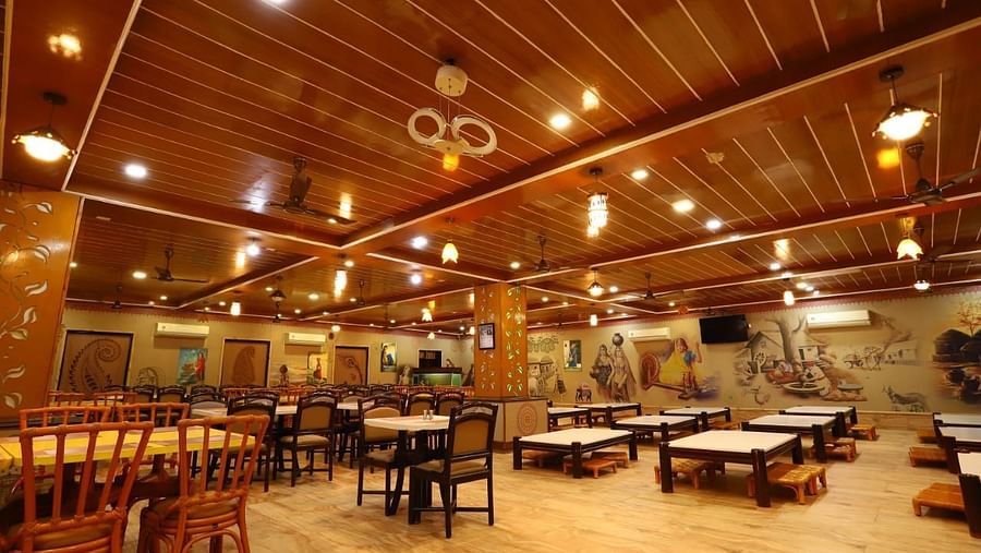 Restaurants fully furnished with wooden tables and chairs with warm lighting.