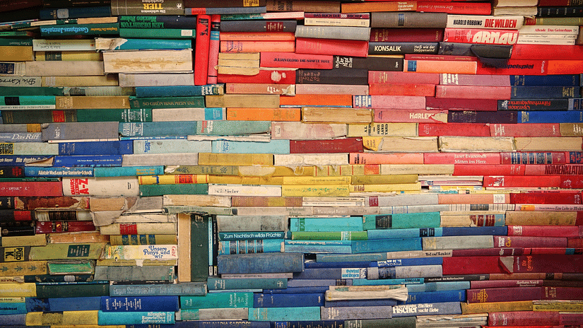 a close up image of Multiple stacks of colourful books