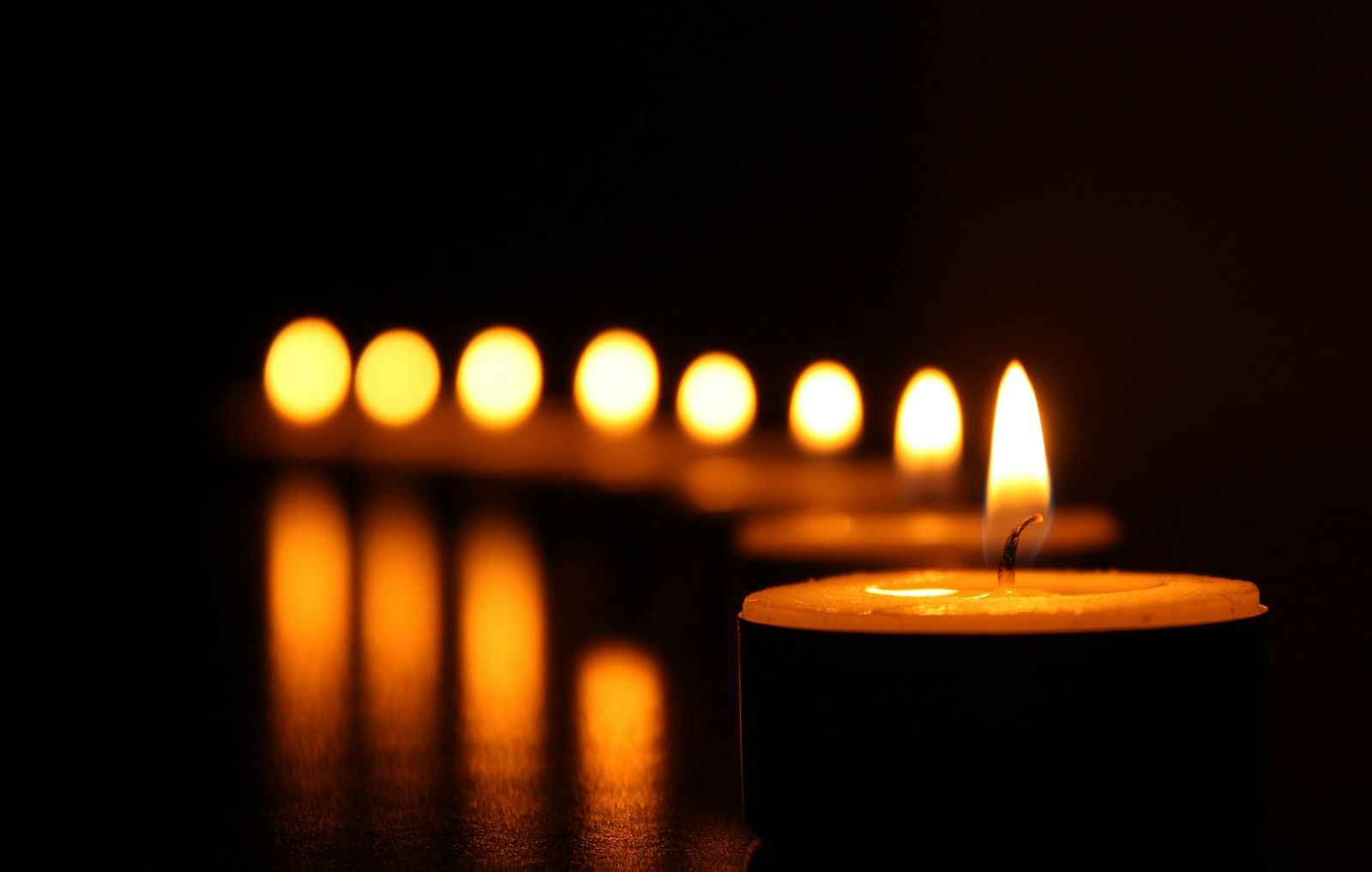 Candles neatly arranged next to each other.
