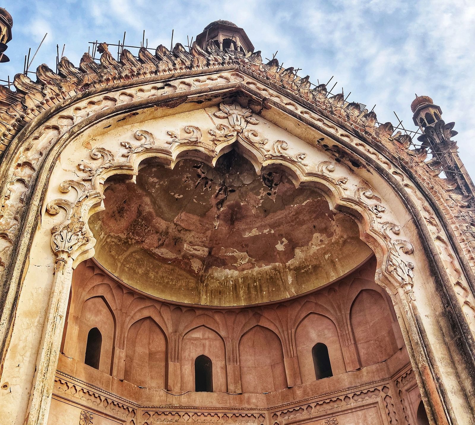 Low-angle view of an intricately designed historical monument with sky in the background