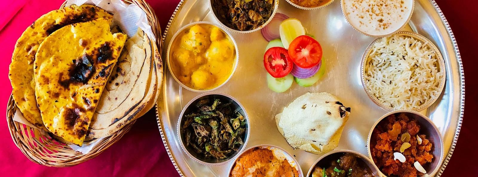 Colourful thali with various Indian dishes, served on a round plate, rich in flavors.