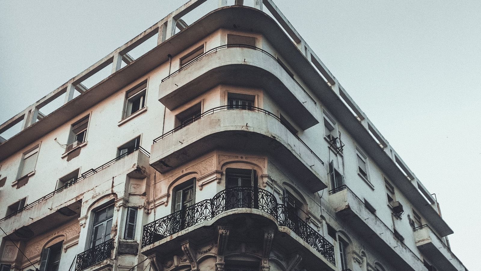 an old building as seen from below with the sky in the background