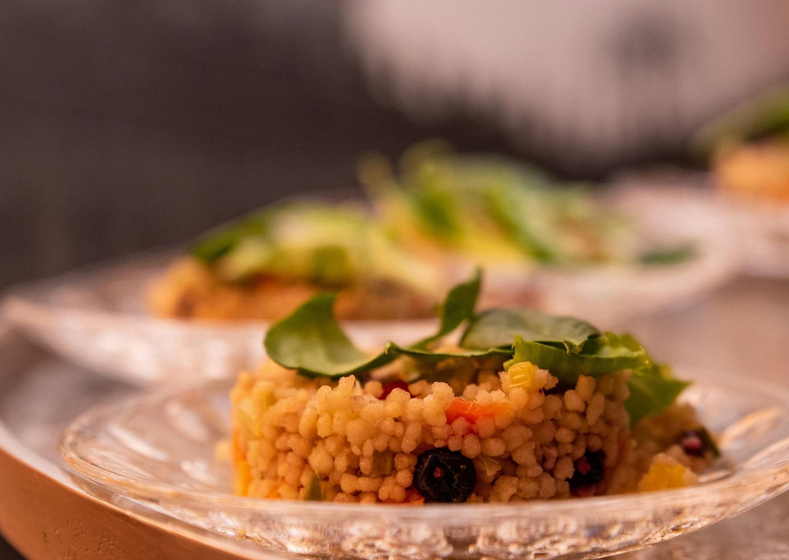 image of a dish made of rice served on a white china plate garnished with green veggies and herbs
