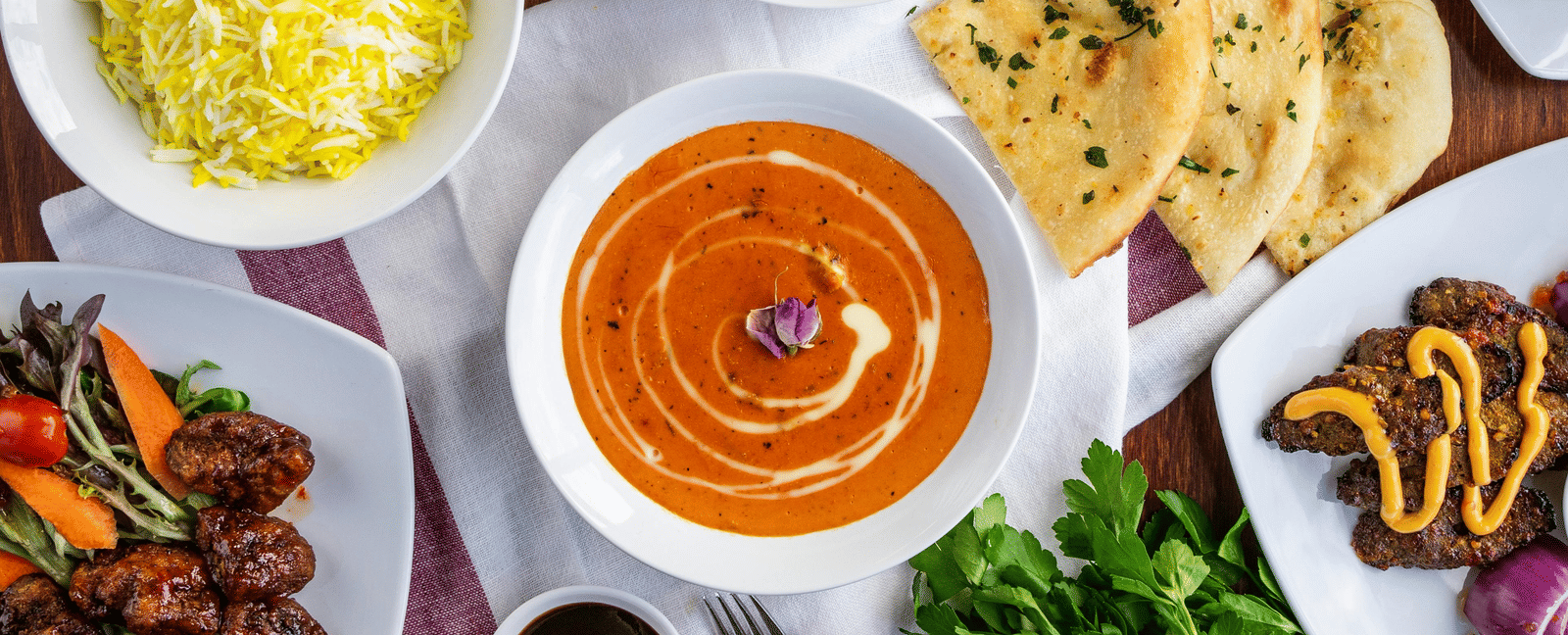 A top shot of a delicious spread of various Indian dishes served on a table.