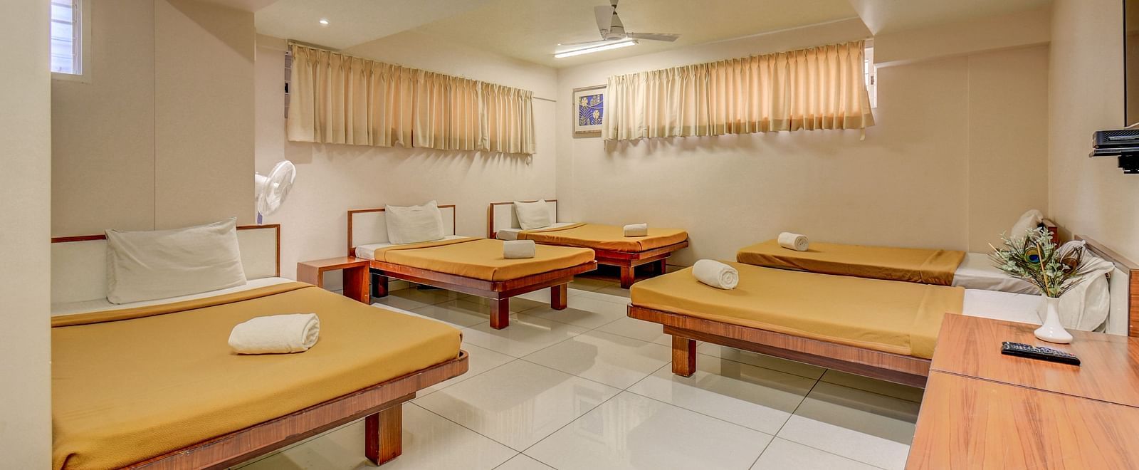 A spacious room with neatly made single beds at Hari Govinda’s JN Stay, Shakthinagar