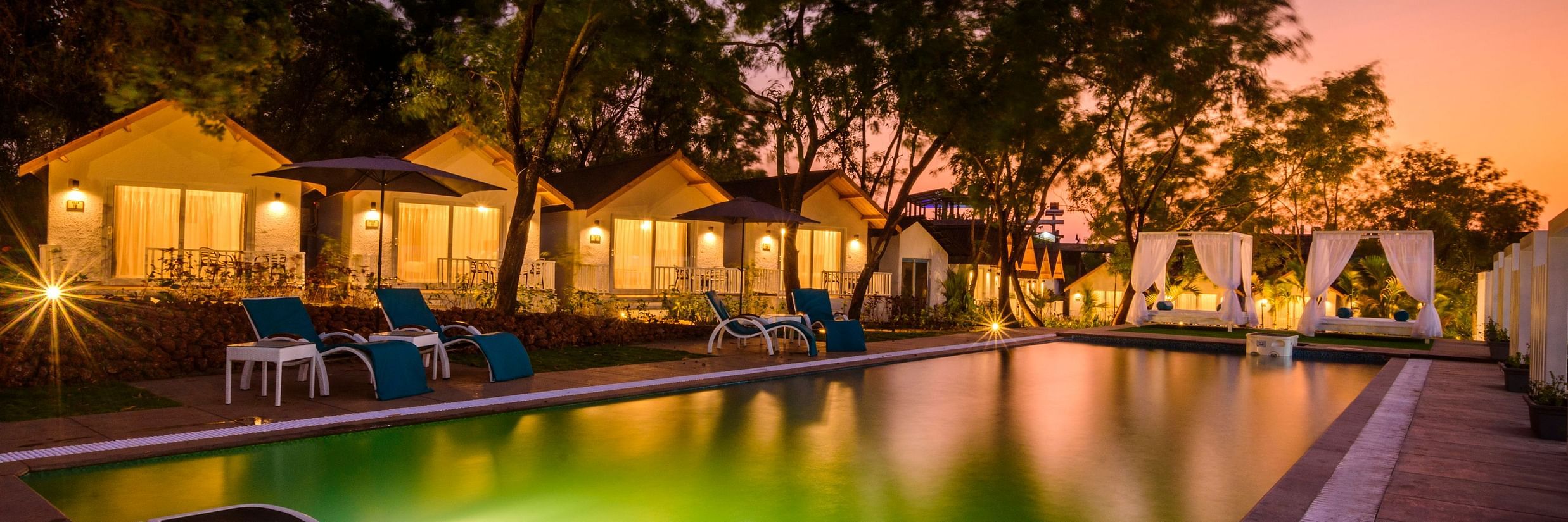 white wood resort and spa swimming pool illuminated at night