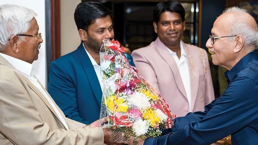 An image of an old man receiving a welcoming bouquet by three other men - Cloud9 Sarovar Premiere, Palolem Goa