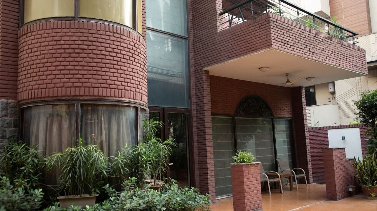 Facade of Redbrick home by earthaa escapes