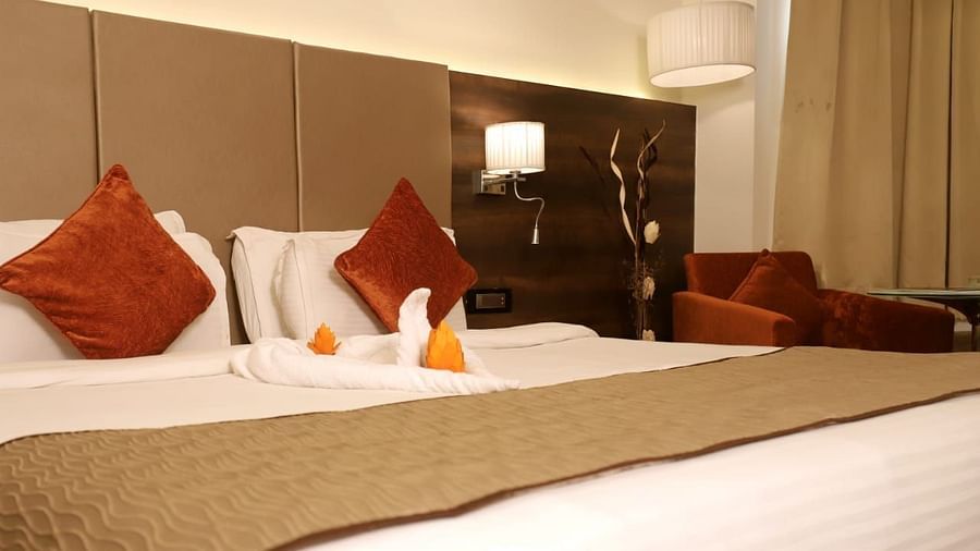 a close up shot of the double bed inside deluxe rooms at 5 flowers ananta elite, kota