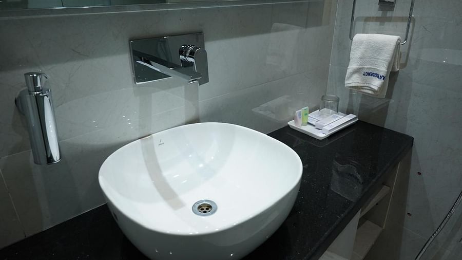 Modern wash basin setup with toiletries in the bathroom at Kalyan Residency Hotel, Tirupati – sleek and well-maintained.