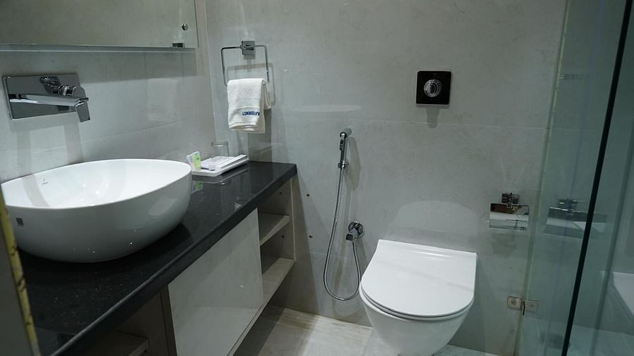 Modern bathroom with glass shower, wash basin, and WC at Kalyan Residency Hotel, Tirupati – clean and well-equipped.
